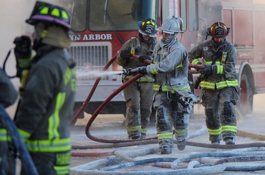 Ann Arbor firefighters January 7 at the Happy's Pizza fire.  -Melanie Maxwell / The Ann Arbor News