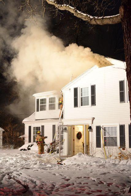 Smoke Reading Tip: Look at the brown smoke coming from the gable vent and how quick it turns white due to the cold air.  The fire has a grip on the structure.  Pic from www.sanduskyregister.com